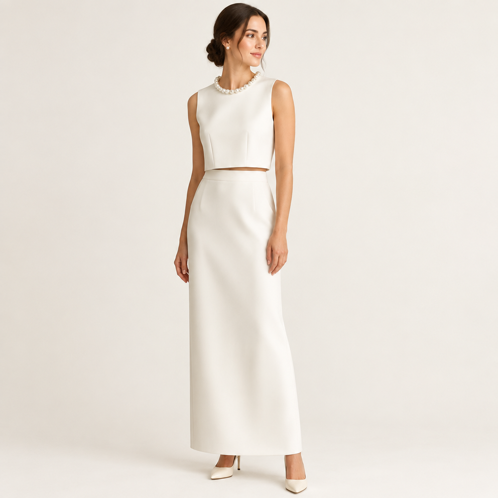 Angled studio view of white sleeveless top and long skirt on model